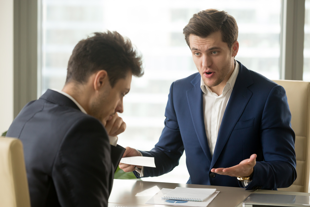 angry mean boss yelling at employee for missing deadline
