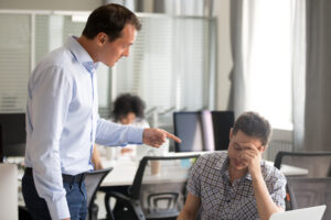 Angry boss ceo scolding rebuking incompetent office worker intern