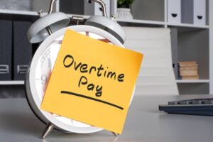 Overtime pay inscription on the alarm clock.