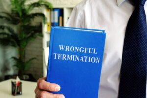 Wrongful termination. The employee holds a book in his hands.