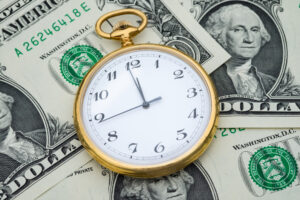 Management efficiency concept of time and money, pocket watch and US dollar banknotes